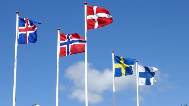 Skandinavien Fahnen von Norwegen, D&auml;nemark, Schweden, Island, Finnland im Wind vor blauen Himmel