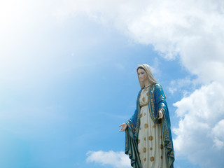 The Blessed Virgin Mary Statue blue sky background.
