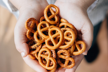 Woman holding hip of pretzel or bretzel in hands