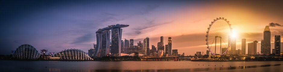 Panorama image of Singapore Skyline and view of skyscrapers on Marina Bay view from the garden by the bay at sunset. - obrazy, fototapety, plakaty