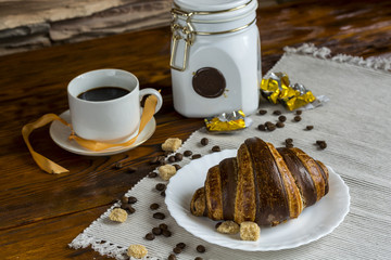 coffee and croissants on black background