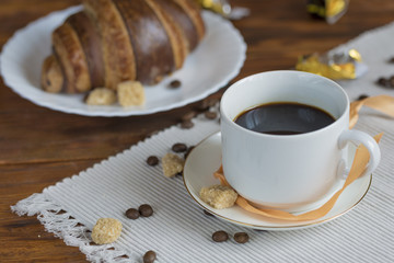 coffee and croissants on black background