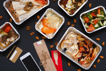 Healthy food take away in boxes, background on black