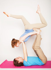 Fototapeta na wymiar lifestyle, sport and people concept: Young couple in yoga pose