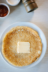 Top view of table with russian pancakes with butter on it
