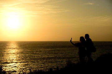 Fototapeta na wymiar Silhouettes freedom people living a sunset happiness.