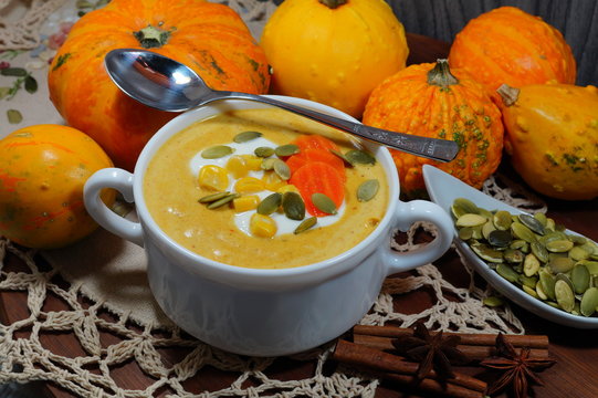 Spicy pumpkin soup in a white bowl, selective focus