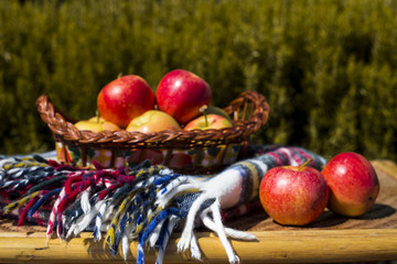 Autumn harvest concept. Red apples on a straw wicker table and in a basket
