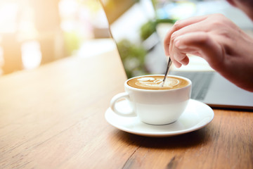 Hand that is brewing coffee latte art.