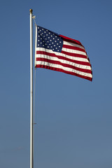 American flag on the blue sky