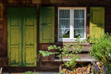 Fototapeta na wymiar Rustic window at farm house in Lenk Switzerland