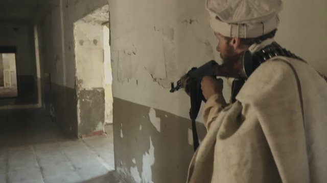 Armed Men attack the enemy in the abandoned building