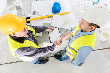 Architect and construction engineer handshake.