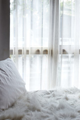 white bedroom with white curtain on window