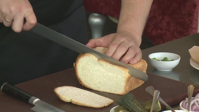 Slicing Bread Slicing Whole Grain Bread Loaf Male hands Slicing bread on table