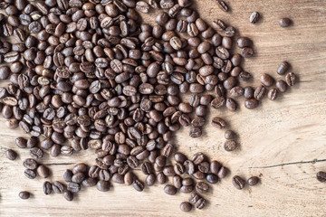 Group of coffee bean on teak wood with nice texture