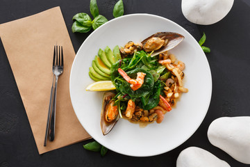 Warm salad with grilled seafood flat lay