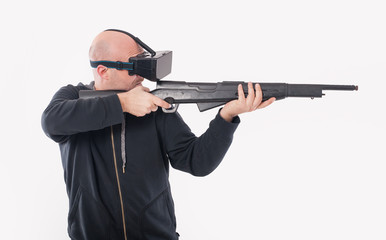 Man play VR shooter game with vr rifle and glasses