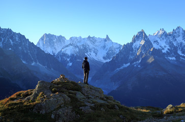 Naklejka na ściany i meble Man looking at the mountains near Chamonix, France.