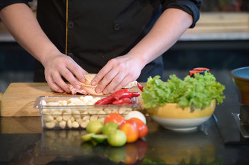 Close Up hands chef cooking raw material in the kitchen