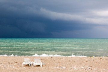 Obraz na płótnie Canvas A big thunderstorm is coming and everybody has left the beach