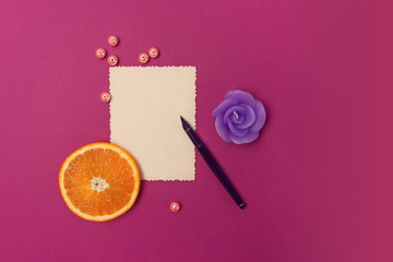 Empty leaf, pen, orange and candle.