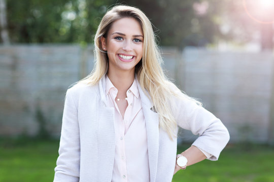 Fototapeta Outdoor close up portrait of young beautiful happy smiling woman