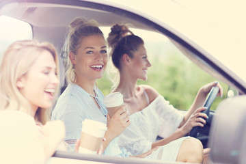 Young women traveling by car with map