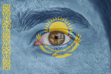 Human face and eye painted with flag of Kazakhstan