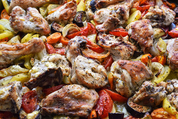 Chicken, cut into pieces, baked with vegetables in the oven