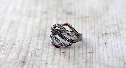 bijoux ,used ring with gems on wood background