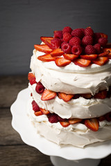 Raspberry and Strawberry Pavlova: an Australian Dessert with Meringue, Whipped Cream, and Fresh Fruit