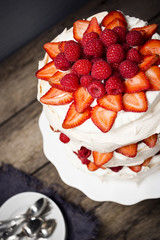 Raspberry and Strawberry Pavlova: an Australian Dessert with Meringue, Whipped Cream, and Fresh Fruit