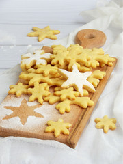 Christmas shortbread cookies in the form of snowflakes sprinkling sugar on white background