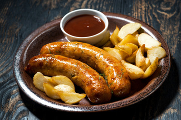 fried pork sausages with potatoes and ketchup