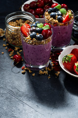 healthy blueberry with granola and fresh berries and dark background
