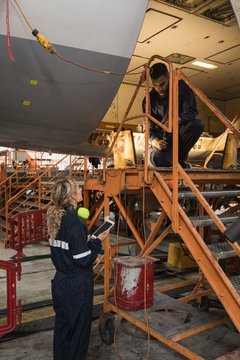 Aircraft maintenance engineers working over an aircraft