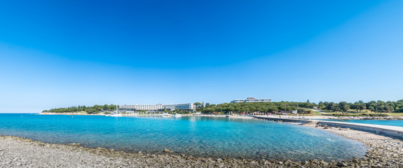 Seaside hotel with beach and turquoise water, Sveti Andrija or Red island near Rovinj, Croatia