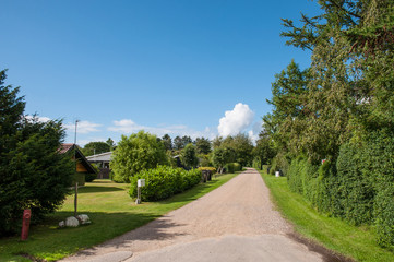 Fototapeta na wymiar Gravel road in town of Salvig on Oroe island in Denmark