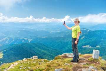 Young woman taking selfie on smartphone