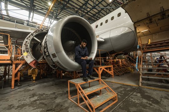 Aircraft maintenance engineer using digital tablet