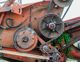 Gears and gear chains. Mechanisms of an old combine harvester. Old technics.