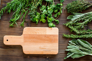 drying fresh herbs and greenery for spice food on wooden kitchen desk background top view space for text