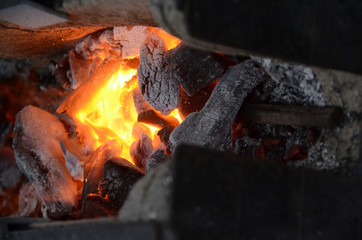 Coal glows in a smiths portable forge.