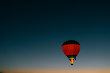 Glowing and blinking balloons flight with people high in sky in night. Freedom concept. Romantic recreation. Hot air balls competition. Autumn ballooning festival. Travel and tourism. Airship journey.