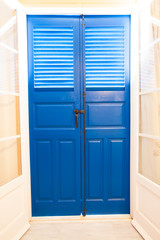 Blue door and window  with shutters