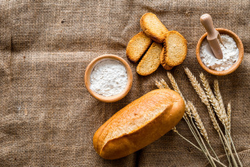 baking fresh wheaten bread on bakery work table background top view