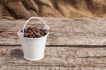 Fototapeta na wymiar Roasted coffee beans in bucke