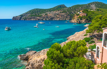 Naklejka na ściany i meble Beautiful coast bay with boats in Camp de Mar on Majorca island, Spain Mediterranean Sea