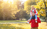 happy family father and  child   daughter playing and laughing in autumn park.